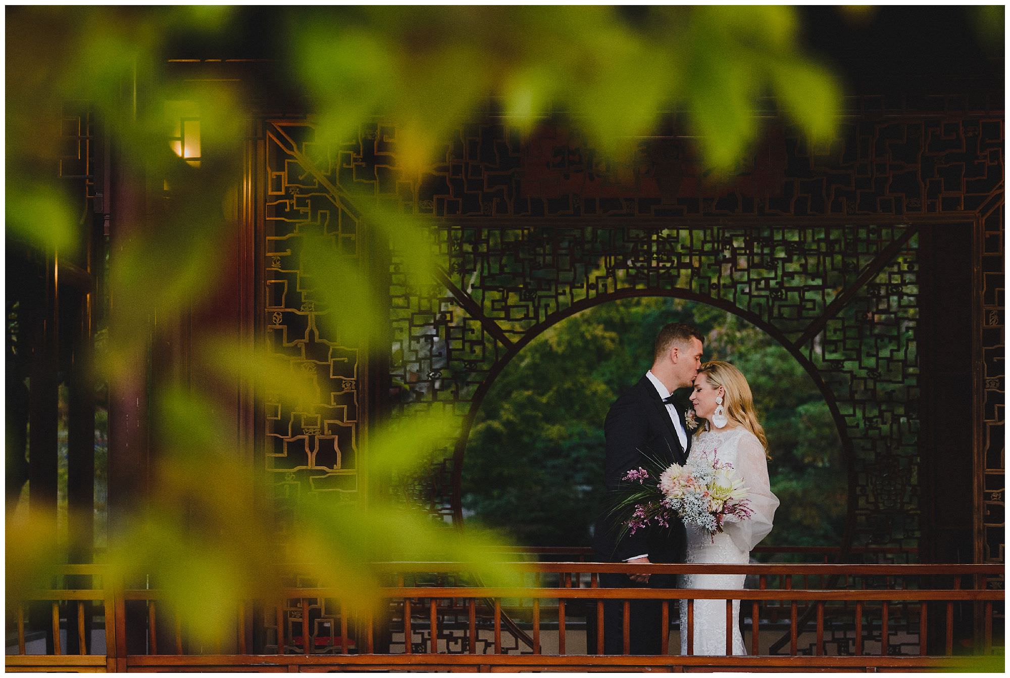 Bride and Groom kiss at sunset after their wedding ceremony at Dr. Sun Yat-Sen Classical Chinese Gardens, elopement, intimate wedding, candid wedding photography