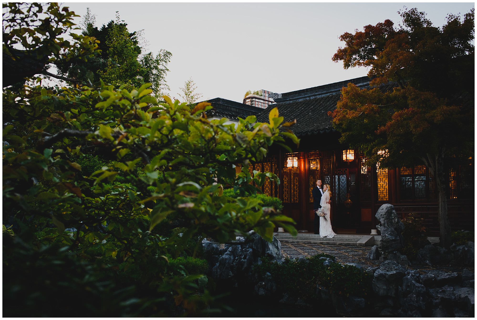 stylish bride and groom at sunset after their wedding ceremony at Dr. Sun Yat-Sen Classical Chinese Gardens, elopement, intimate wedding, candid wedding photography, downtown Vancouver wedding photo