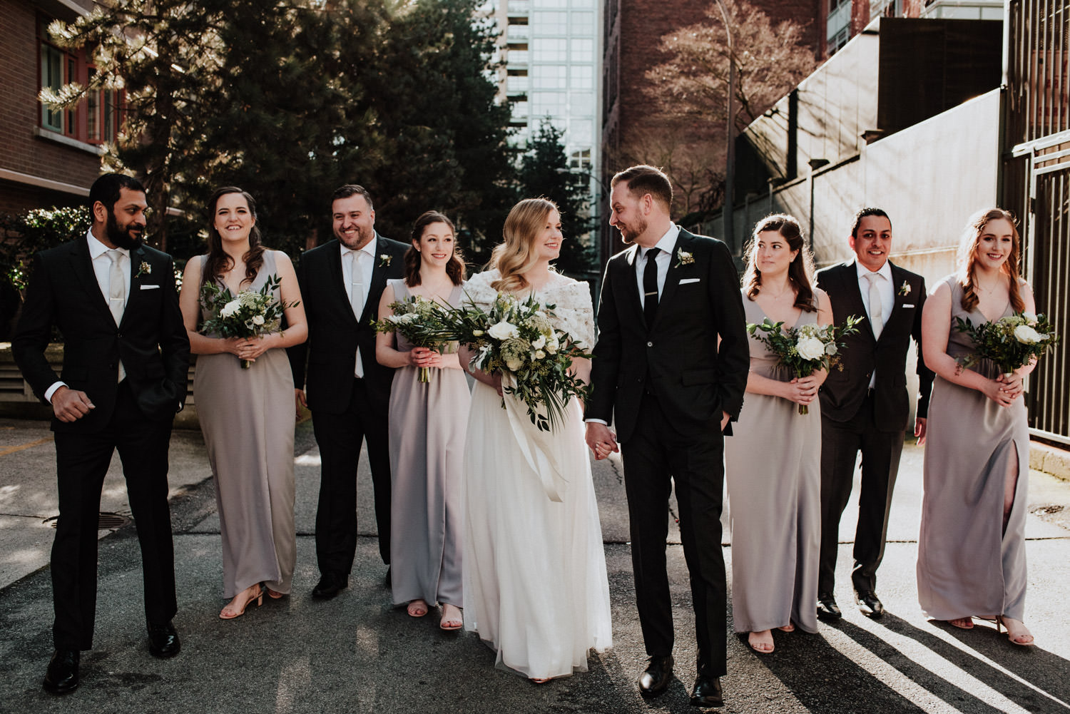 bridal party walking through sunny alley in Yaletown